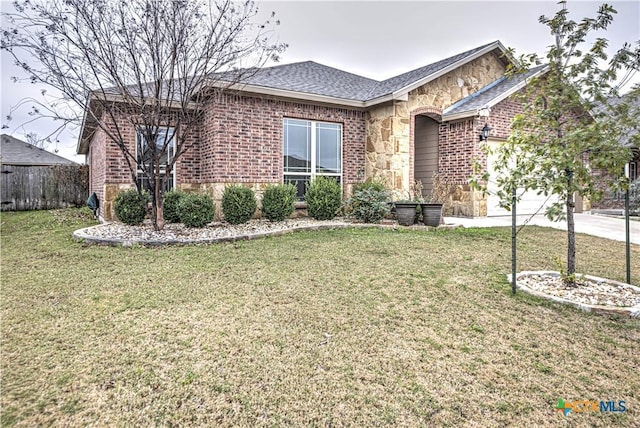 ranch-style home with brick siding, concrete driveway, a garage, stone siding, and a front lawn