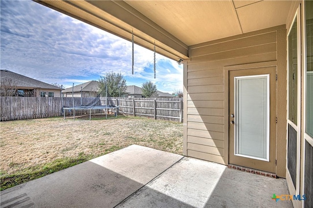 view of patio / terrace with a trampoline and a fenced backyard