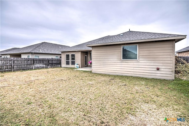 rear view of house featuring a patio and a lawn