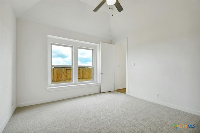 empty room with ceiling fan and light carpet