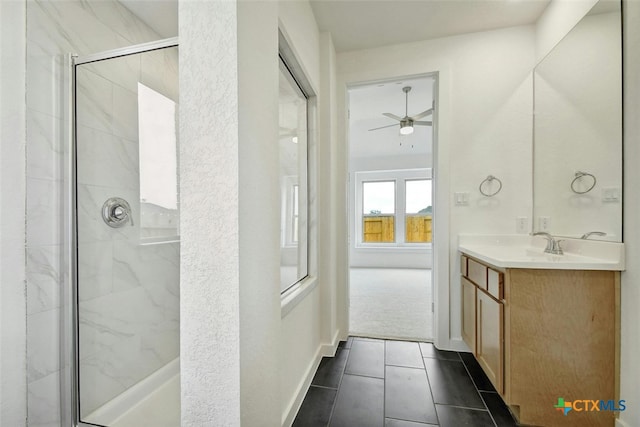 bathroom with vanity, ceiling fan, tile patterned floors, and a shower with door