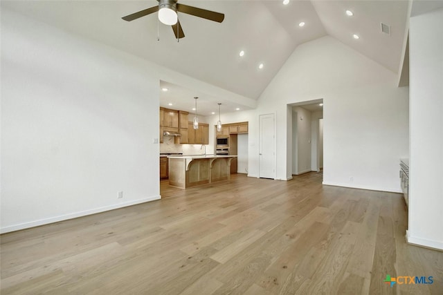 unfurnished living room with high vaulted ceiling, ceiling fan, and light hardwood / wood-style flooring