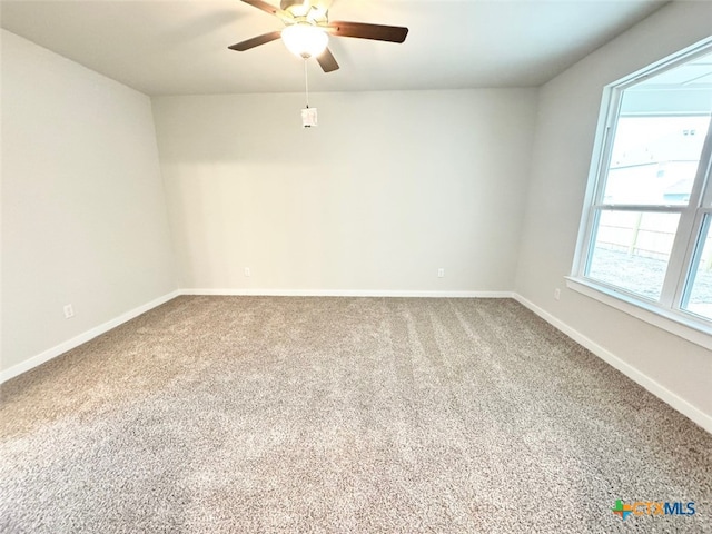 unfurnished room with ceiling fan and carpet flooring