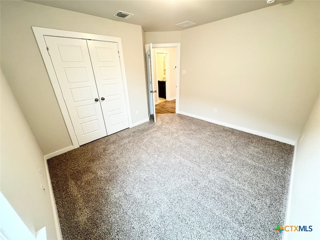 unfurnished bedroom with carpet floors and a closet