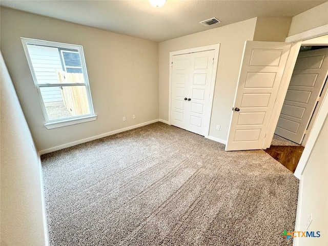 unfurnished bedroom featuring a closet and carpet