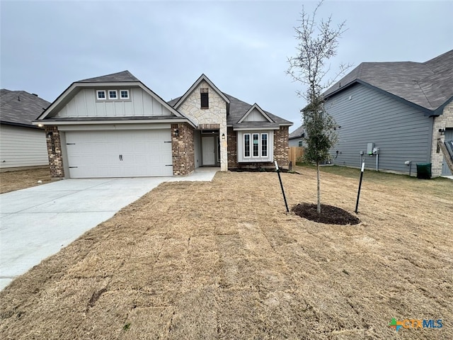 view of front of home featuring a garage and a front lawn