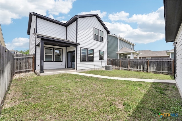 rear view of house with a patio and central AC unit