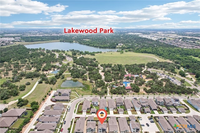 aerial view of property and surrounding area with a large body of water and nearby suburban area