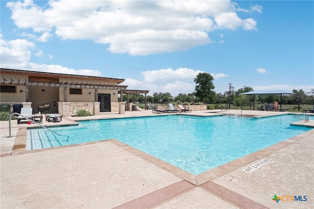 community pool featuring a patio area, a pergola, and fence
