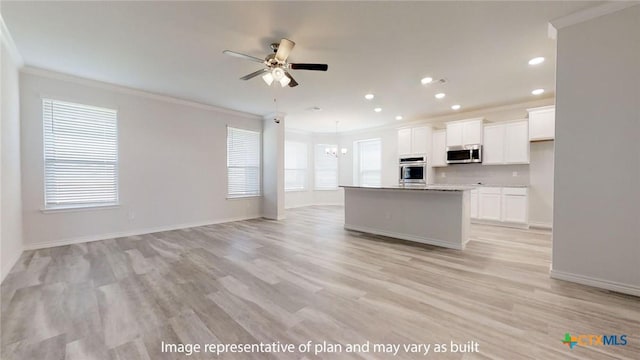 5105 Othello Dr, Belton, TX 76513 - kitchen with appliances with stainless steel finishes, crown molding, open floor plan, ceiling fan, and a chandelier