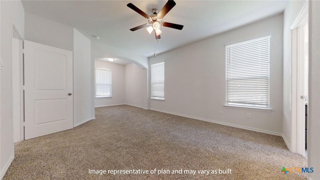 5105 Othello Dr, Belton, TX 76513 - empty room featuring ceiling fan, carpet floors, and arched walkways