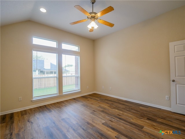 empty room featuring ceiling fan, dark wood-type flooring, and vaulted ceiling