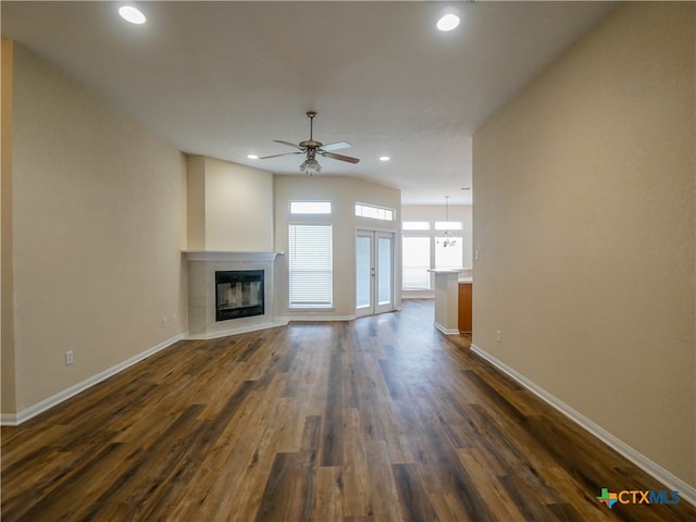 unfurnished living room featuring french doors, dark hardwood / wood-style flooring, and ceiling fan