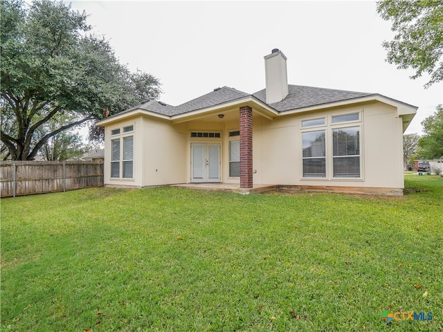 rear view of house with a lawn