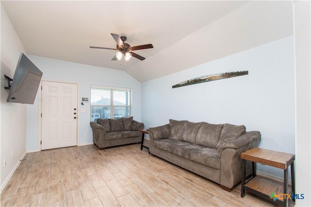 living room with light wood-style flooring, baseboards, vaulted ceiling, and a ceiling fan