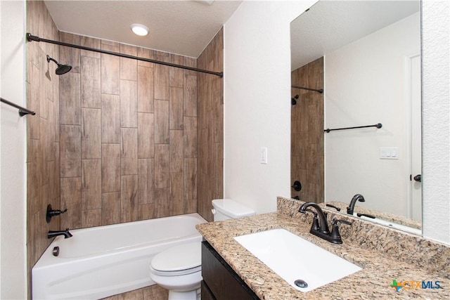 full bath featuring toilet, vanity, a textured ceiling, and bathing tub / shower combination