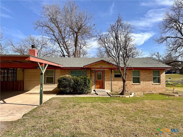 ranch-style home with a front yard, a carport, brick siding, and a chimney