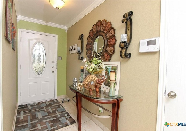 entrance foyer featuring crown molding and tile patterned flooring