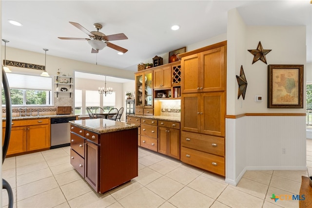 1600 Cattlemens Row, Lockhart, TX 78644 - kitchen featuring open shelves, stainless steel dishwasher, brown cabinetry, ceiling fan, and a wainscoted wall