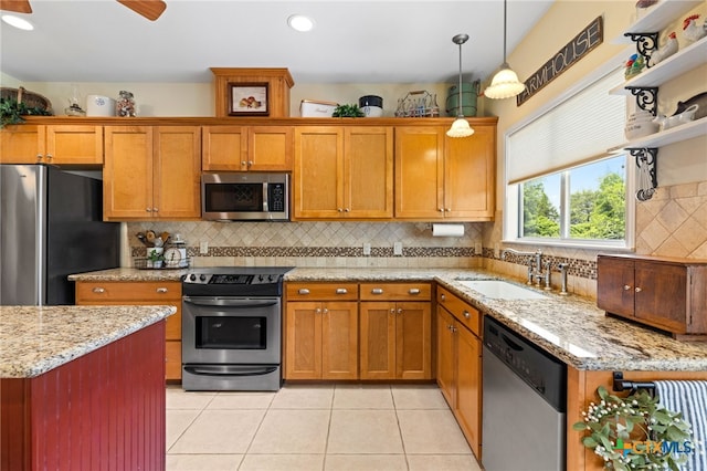 1600 Cattlemens Row, Lockhart, TX 78644 - kitchen with stainless steel appliances, a sink, light tile patterned floors, pendant lighting, and decorative backsplash
