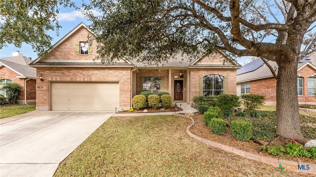 view of front of property with a front yard, brick siding, and driveway