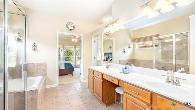 bathroom with tile patterned floors, separate shower and tub, vanity, and ceiling fan