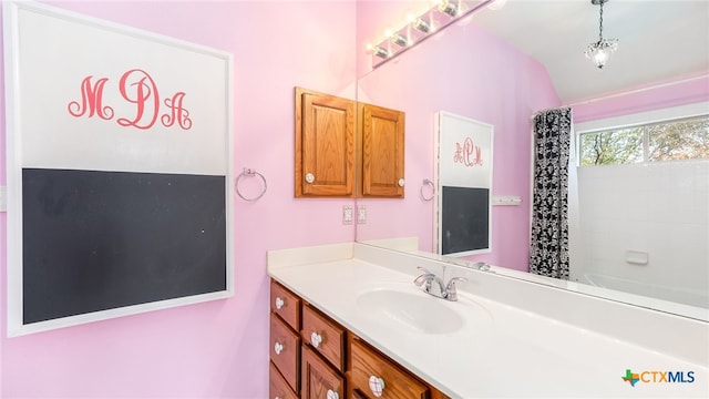 bathroom featuring vanity, shower / bath combination with curtain, and lofted ceiling