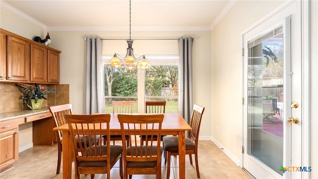 tiled dining room with crown molding, plenty of natural light, built in desk, and a notable chandelier