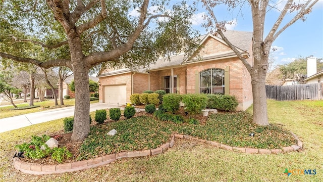 view of front of home featuring brick siding, an attached garage, driveway, and fence