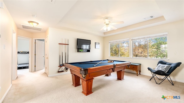 rec room with a tray ceiling, ceiling fan, light colored carpet, and billiards