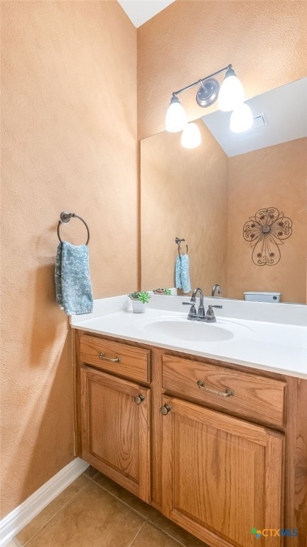 bathroom with tile patterned flooring and vanity