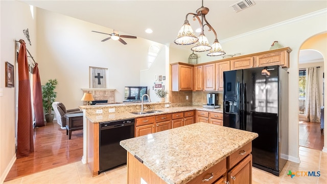 kitchen featuring sink, a center island, kitchen peninsula, and black appliances