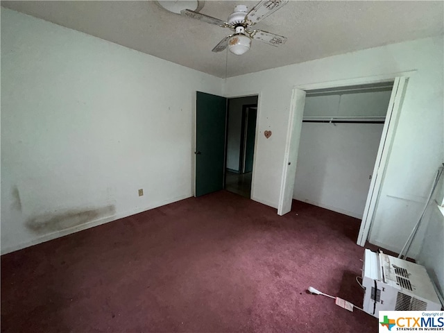 unfurnished bedroom featuring a closet, dark carpet, and ceiling fan