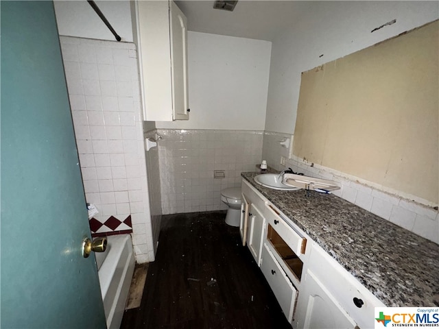 full bathroom with bathtub / shower combination, toilet, vanity, tile walls, and hardwood / wood-style flooring