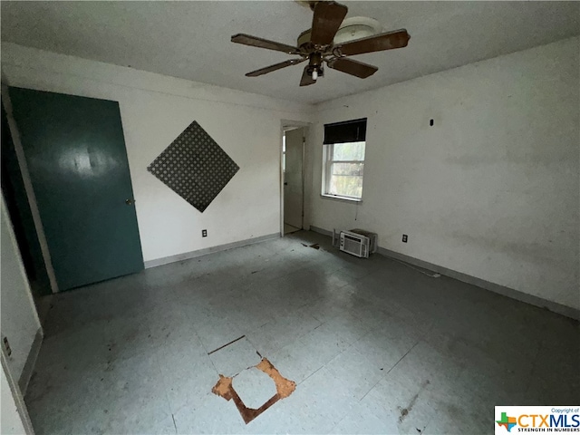 empty room with ceiling fan and a wall mounted AC