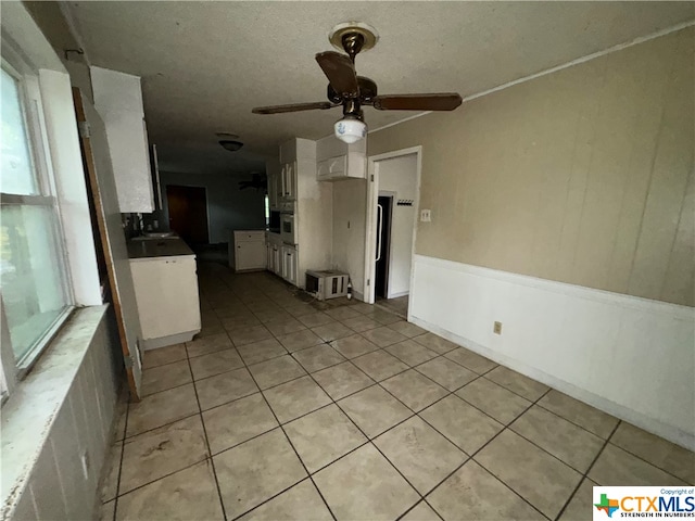 interior space featuring ceiling fan and light tile patterned floors