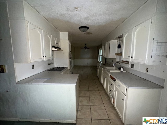 kitchen featuring white cabinets, ceiling fan, sink, and a textured ceiling