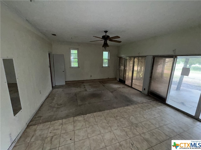 spare room featuring ceiling fan and vaulted ceiling