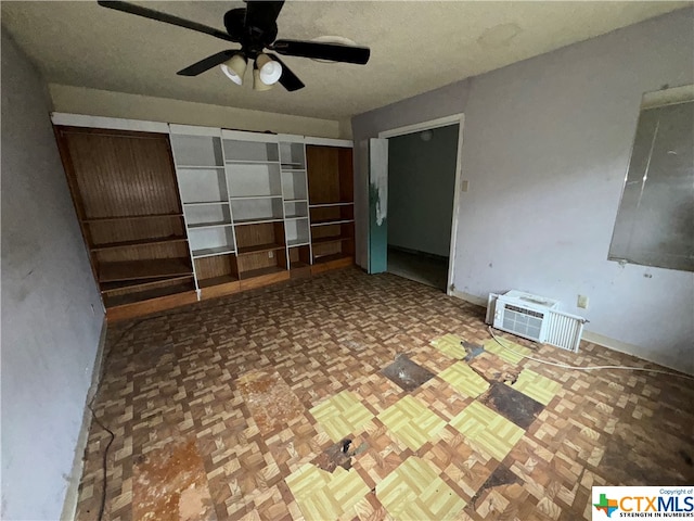 unfurnished bedroom with a wall mounted AC, parquet floors, and ceiling fan