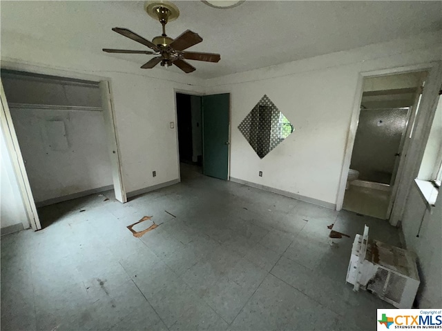 unfurnished bedroom featuring ceiling fan and connected bathroom