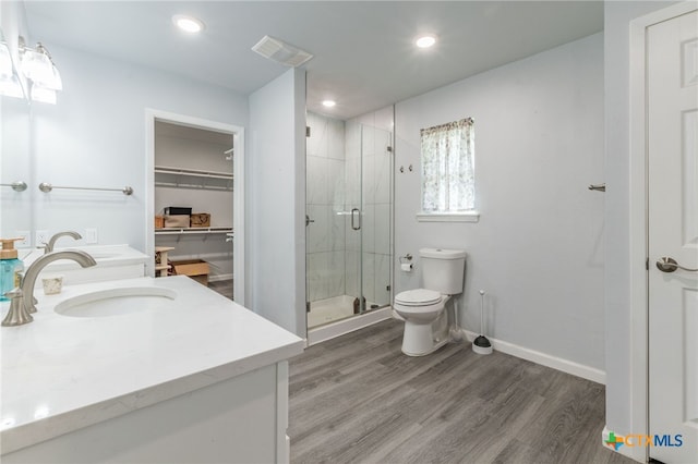 501 College Ave, Florence, TX 76527 - bathroom with vanity, a stall shower, wood finished floors, a spacious closet, and recessed lighting
