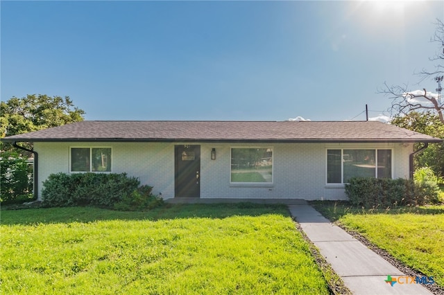 501 College Ave, Florence, TX 76527 - ranch-style house featuring brick siding and a front lawn