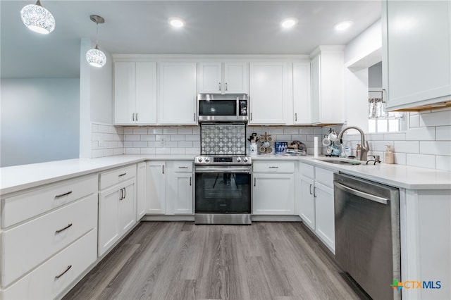 501 College Ave, Florence, TX 76527 - kitchen with stainless steel appliances, white cabinets, tasteful backsplash, light countertops, and recessed lighting