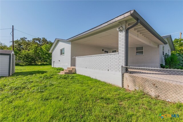 501 College Ave, Florence, TX 76527 - view of home's exterior featuring brick siding and a yard