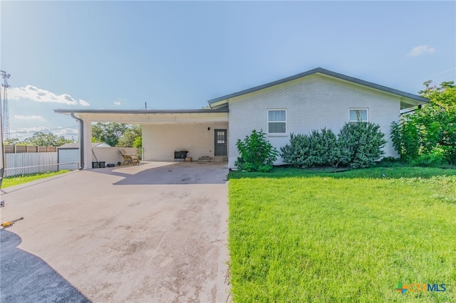 501 College Ave, Florence, TX 76527 - single story home featuring concrete driveway, brick siding, and a carport