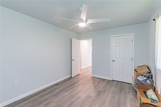 501 College Ave, Florence, TX 76527 - unfurnished bedroom with light wood-style floors and a ceiling fan