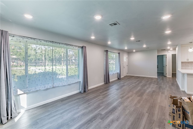 501 College Ave, Florence, TX 76527 - unfurnished living room with wood finished floors and recessed lighting