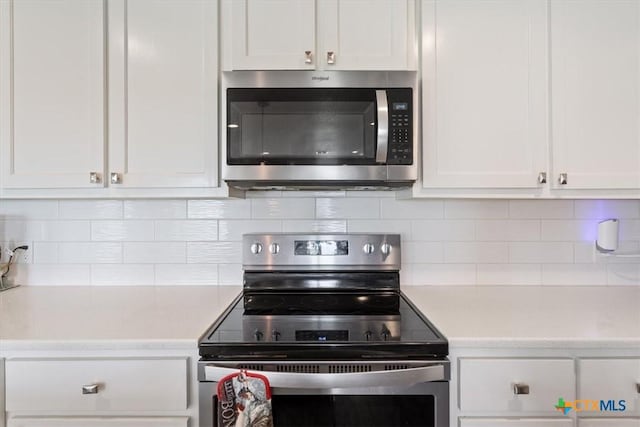 17179 Cyclone Rd, Burlington, TX 76519 - kitchen with appliances with stainless steel finishes, white cabinets, and light countertops