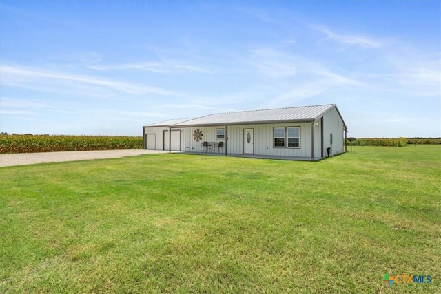 17179 Cyclone Rd, Burlington, TX 76519 - view of front facade with a front lawn, board and batten siding, driveway, an outbuilding, and a detached garage