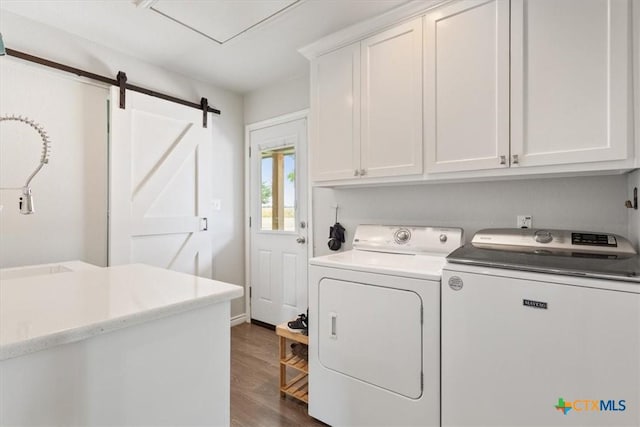 17179 Cyclone Rd, Burlington, TX 76519 - washroom featuring cabinet space, separate washer and dryer, dark wood finished floors, and a barn door